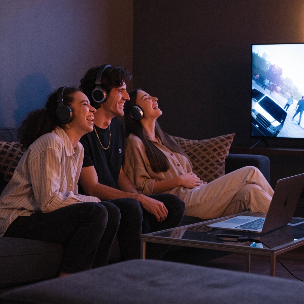 Friends enjoying synchronized audio with multiple wireless headphones